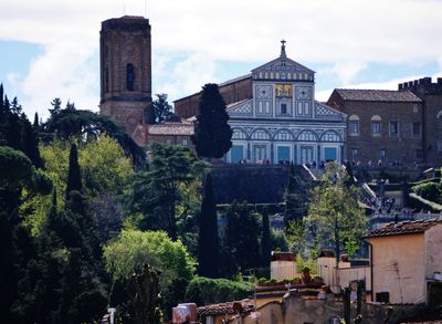 The façade of Basilica di San Miniato al Monte, which features a striking geometric design using white Carrara marble and green Prato serpentine marble.