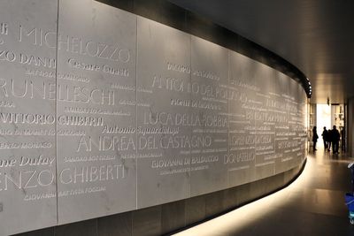 Curved wall in the Museo dell'Opera del Duomo, which features the names of famous artists and architects associated with the Florence Cathedral complex engraved into the marble.