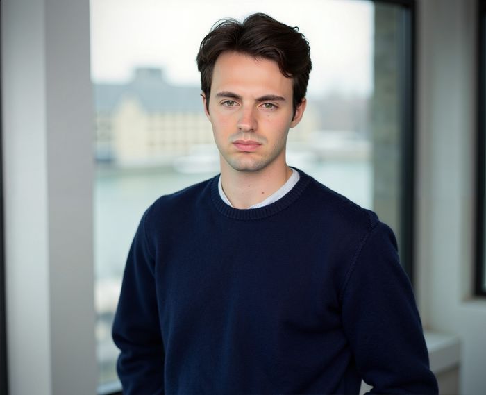 A picture of Riccardo Di Molfetta in front of a big window.